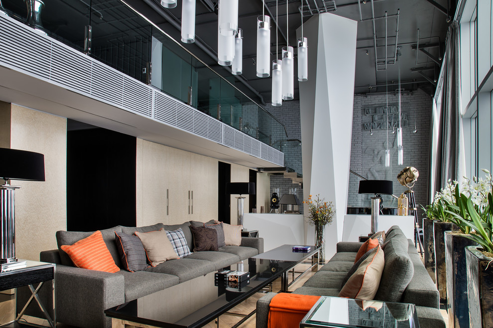 This is an example of a contemporary formal open concept living room in Moscow with light hardwood floors.