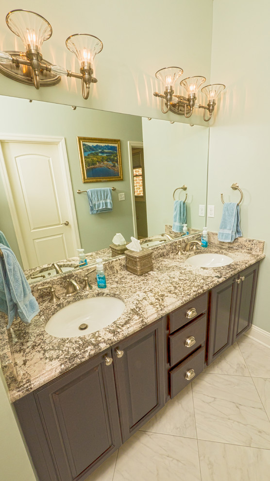 Alcove shower - transitional master white tile and ceramic tile ceramic tile alcove shower idea with an undermount sink, raised-panel cabinets, dark wood cabinets, granite countertops and blue walls