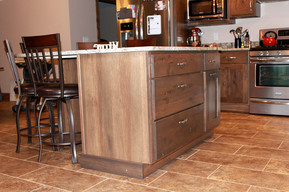 Inspiration for a large rustic l-shaped eat-in kitchen remodel in Chicago with a farmhouse sink, shaker cabinets, dark wood cabinets, granite countertops, stainless steel appliances and an island