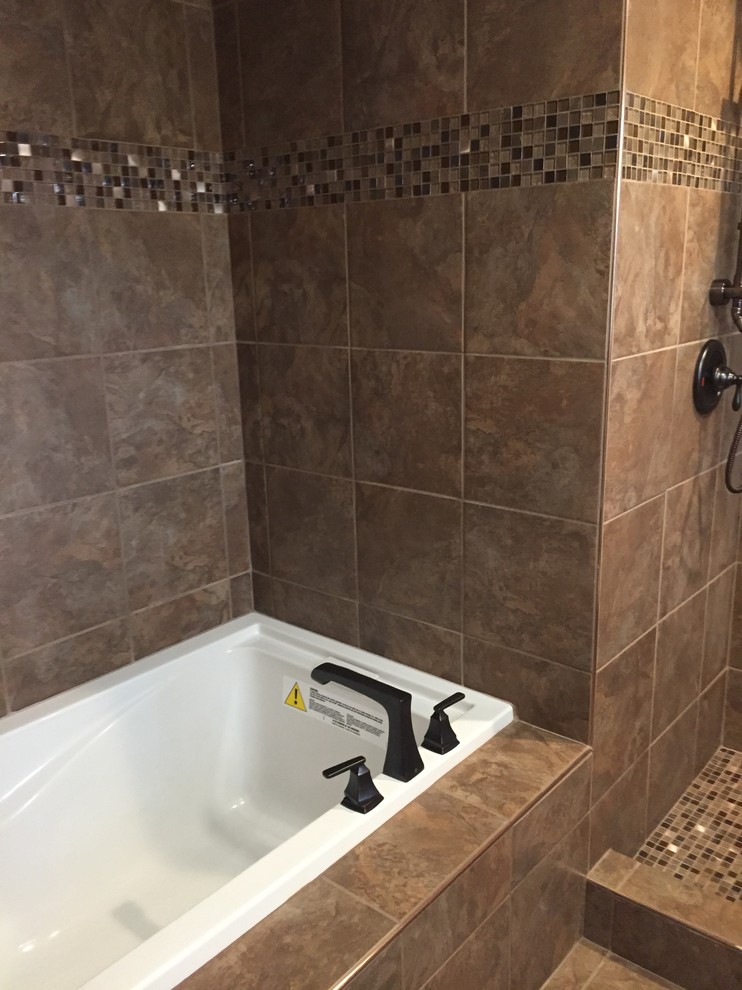 This is an example of a mid-sized transitional master bathroom in Other with a drop-in tub, an alcove shower, a two-piece toilet, brown tile, porcelain tile, brown walls, porcelain floors, brown floor and a shower curtain.