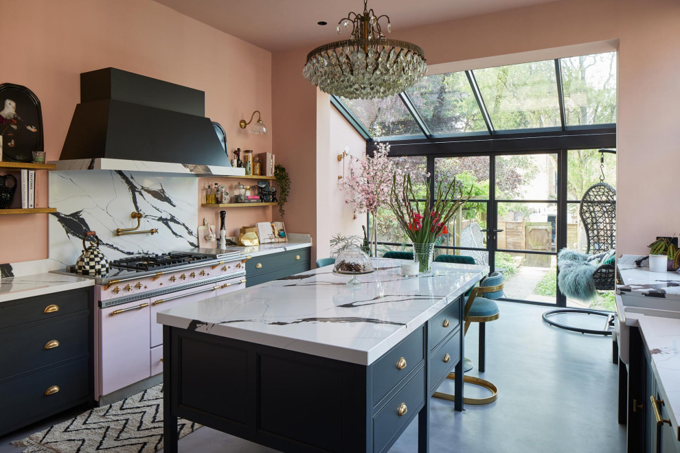 This is an example of a medium sized classic single-wall kitchen/diner in London with a belfast sink, shaker cabinets, blue cabinets, marble worktops, multi-coloured splashback, marble splashback, concrete flooring, an island, grey floors and multicoloured worktops.
