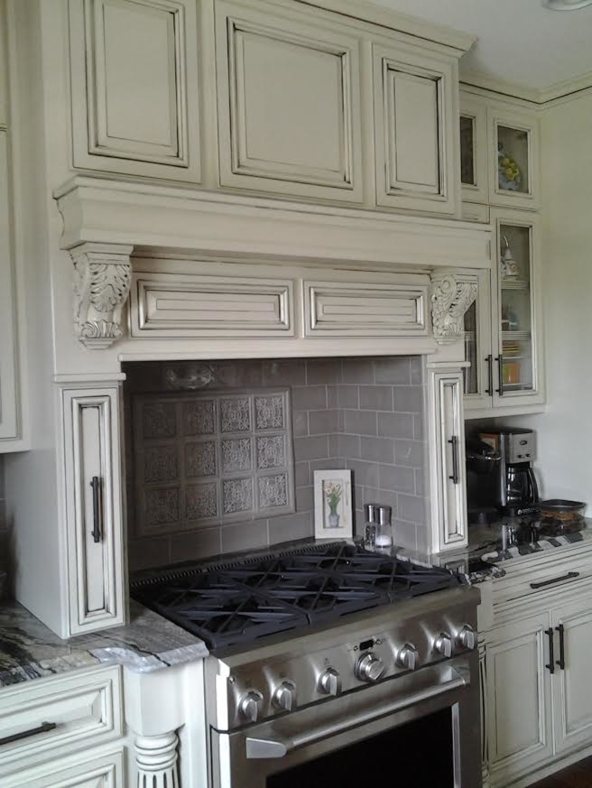 Example of a mid-sized transitional l-shaped dark wood floor and brown floor enclosed kitchen design with an undermount sink, distressed cabinets, granite countertops, stainless steel appliances, raised-panel cabinets, gray backsplash, subway tile backsplash and an island
