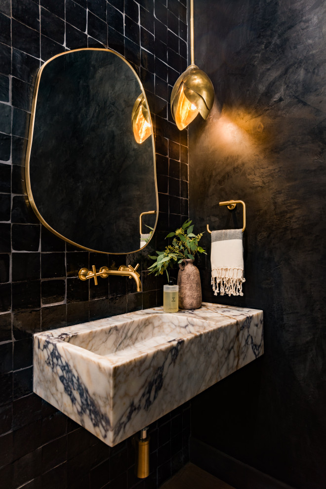 Transitional powder room photo in Tampa with black walls and a wall-mount sink
