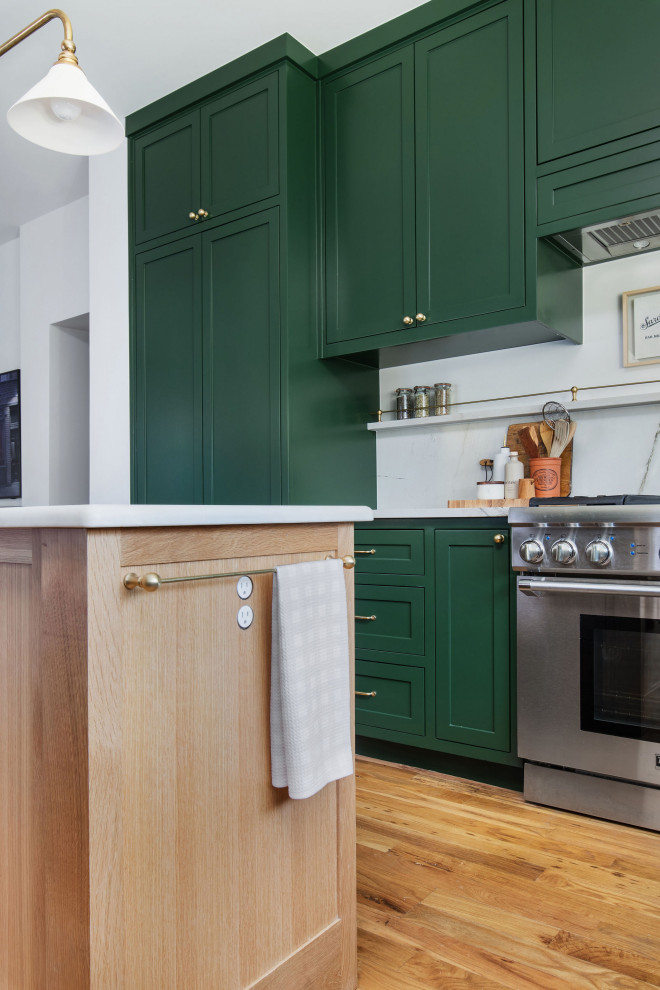 Mid-sized transitional u-shaped medium tone wood floor and brown floor open concept kitchen photo in Austin with an undermount sink, shaker cabinets, green cabinets, quartzite countertops, white backsplash, stone slab backsplash, stainless steel appliances, an island and white countertops