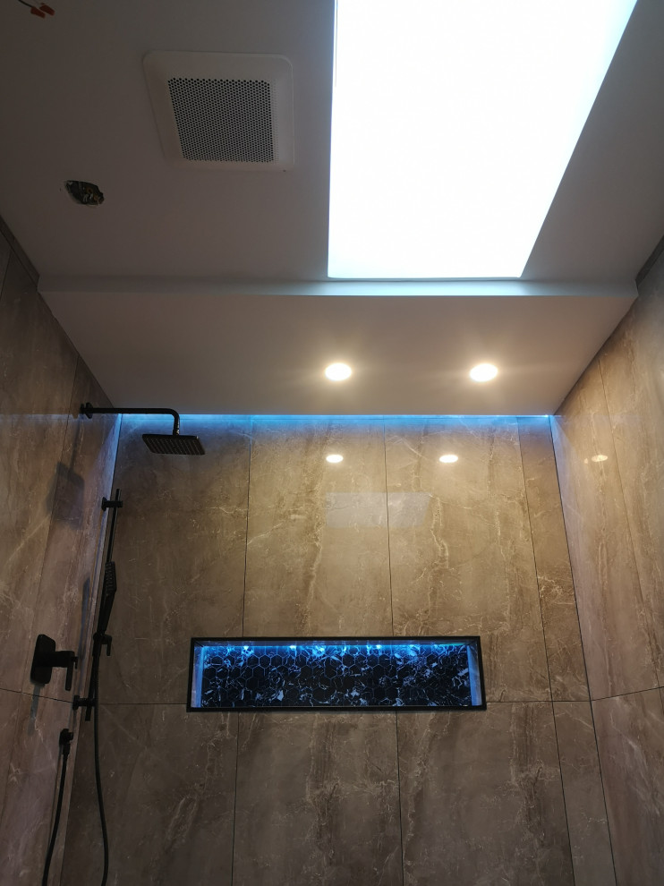 Photo of a medium sized modern shower room bathroom in Toronto with flat-panel cabinets, medium wood cabinets, a submerged bath, a built-in shower, a one-piece toilet, grey tiles, porcelain tiles, grey walls, porcelain flooring, a vessel sink, quartz worktops, grey floors, an open shower, multi-coloured worktops, a wall niche, a single sink, a floating vanity unit, a vaulted ceiling and brick walls.