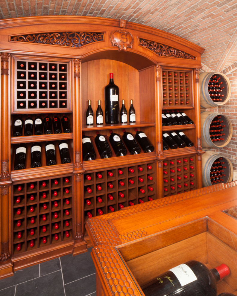 This is an example of an expansive traditional wine cellar in New York with ceramic floors, display racks and grey floor.