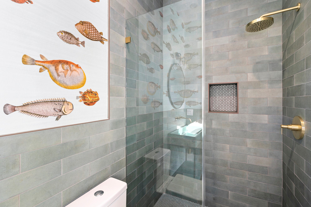 Photo of a medium sized nautical shower room bathroom in Los Angeles with open cabinets, turquoise cabinets, an alcove shower, a two-piece toilet, grey tiles, cement tiles, white walls, cement flooring, a vessel sink, white floors, a hinged door, a single sink, a built in vanity unit, glass worktops, turquoise worktops and a wall niche.