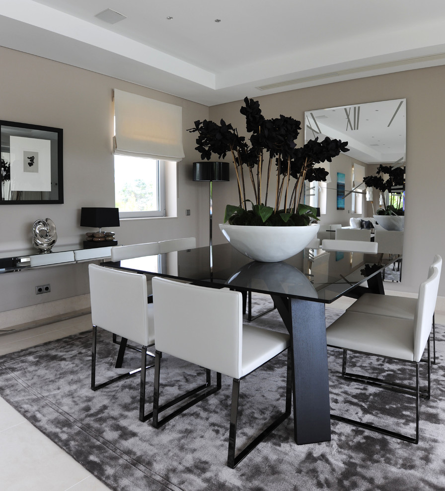 This is an example of a contemporary dining room in Other with grey walls.