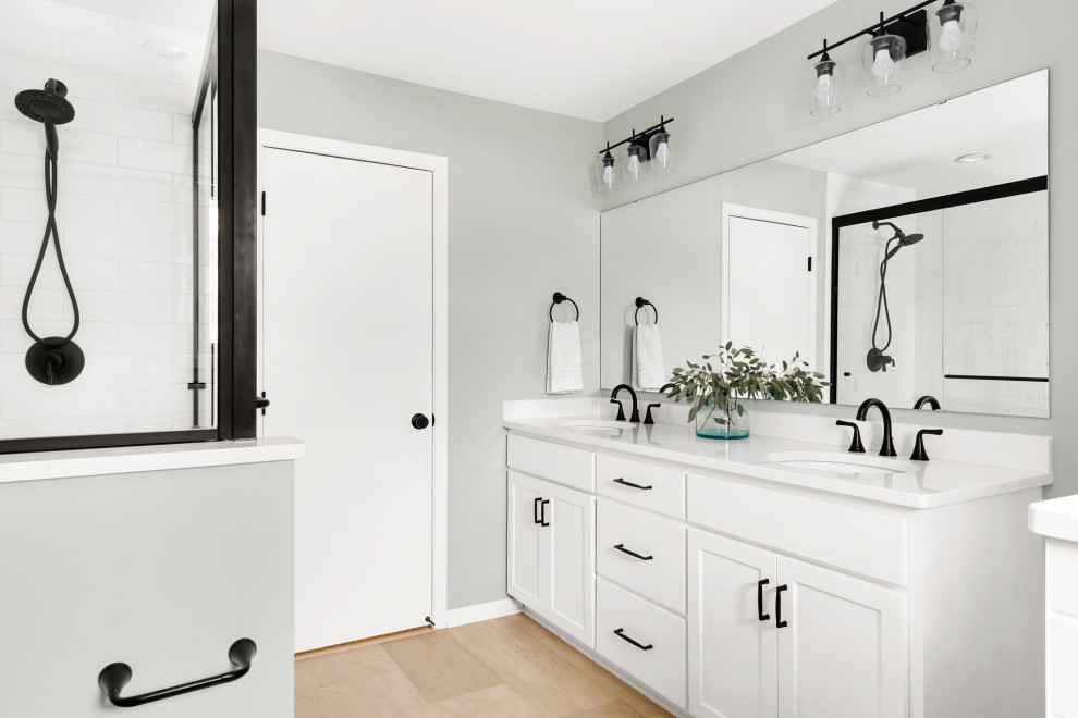 Example of a minimalist double-sink bathroom design in Minneapolis with white cabinets and quartz countertops