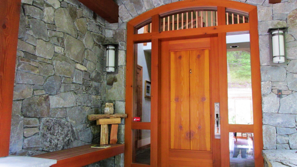 Front door - large rustic front door idea with a medium wood front door