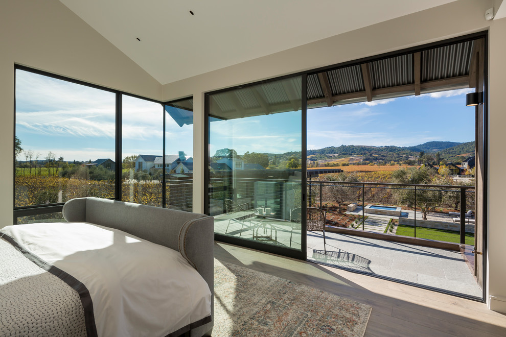 Huge trendy master light wood floor and brown floor bedroom photo in San Francisco with white walls