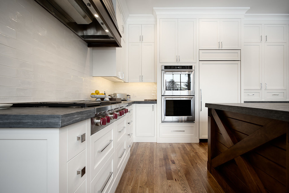 Inspiration for a large transitional u-shaped eat-in kitchen remodel in Calgary with shaker cabinets, paneled appliances and an island