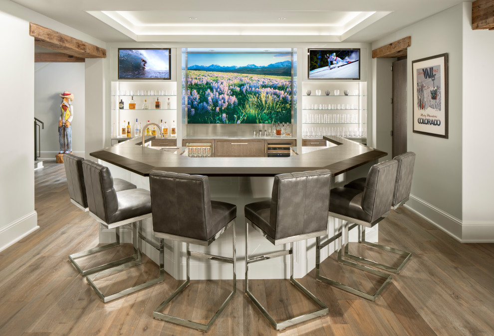 Mid-sized mountain style u-shaped medium tone wood floor and gray floor seated home bar photo in Denver with an undermount sink, recessed-panel cabinets, gray cabinets, wood countertops, white backsplash and white countertops