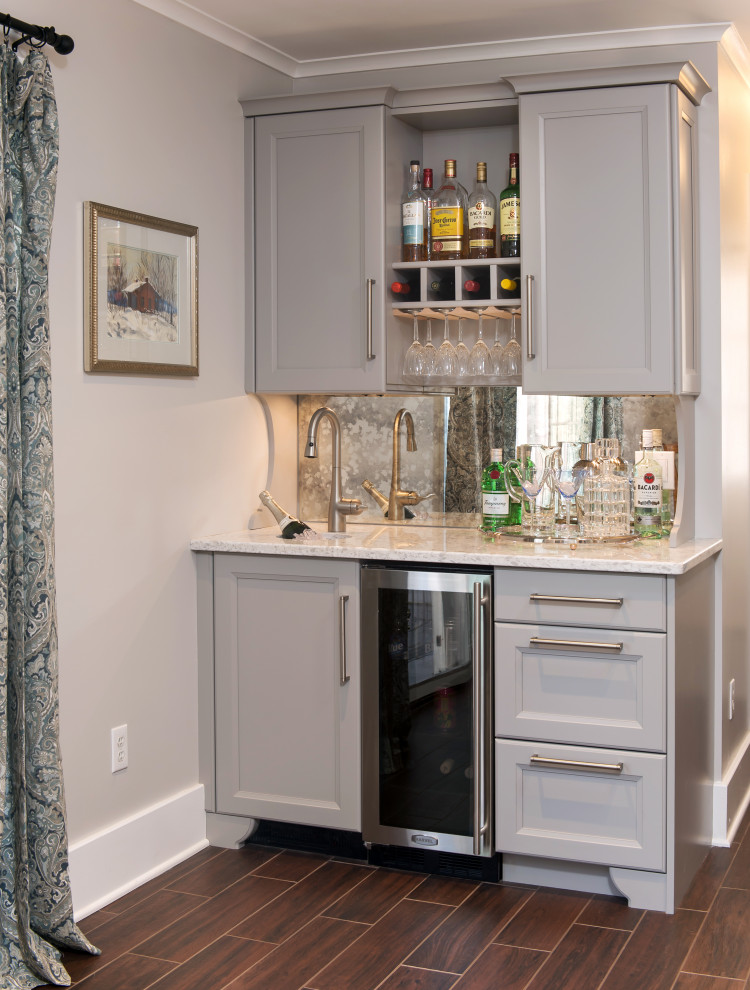 Inspiration for a small transitional single-wall wet bar in Boston with an undermount sink, grey cabinets, quartzite benchtops, mirror splashback, porcelain floors, brown floor and white benchtop.