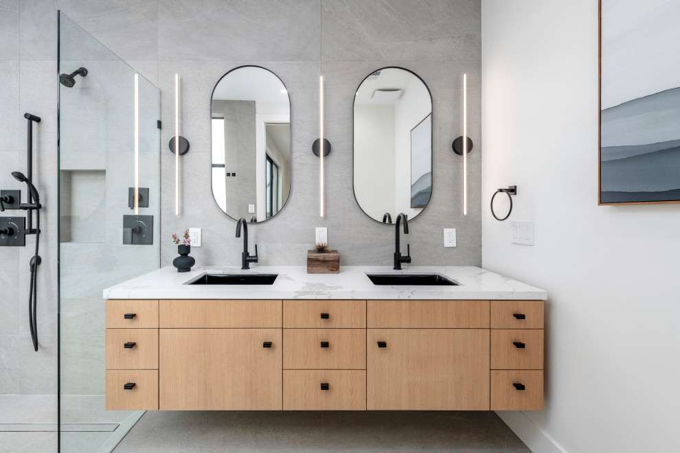 This is an example of a mid-sized contemporary master bathroom in San Francisco with flat-panel cabinets, gray tile, porcelain tile, porcelain floors, an undermount sink, engineered quartz benchtops, an open shower, white benchtops, a niche, a double vanity, a floating vanity, beige cabinets, a curbless shower, white walls and grey floor.