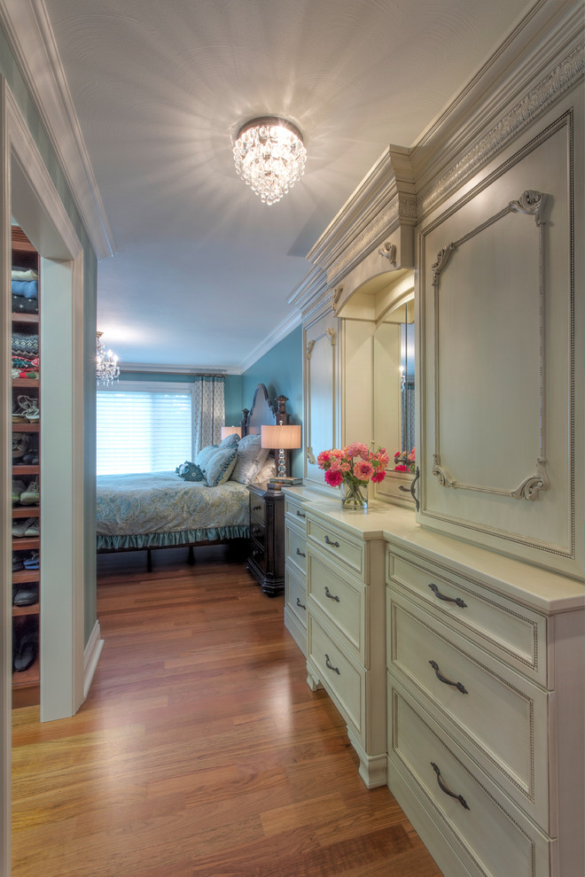 Inspiration for a mid-sized traditional master bedroom in Other with blue walls and medium hardwood floors.