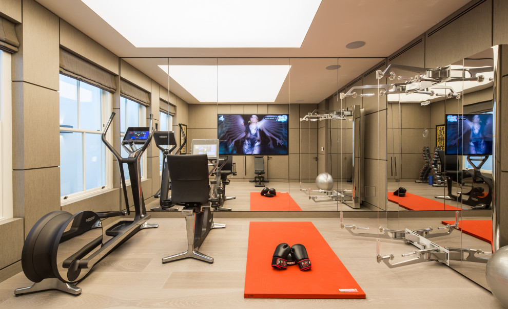 Inspiration for a contemporary home gym in Hampshire with grey walls, light hardwood floors and beige floor.