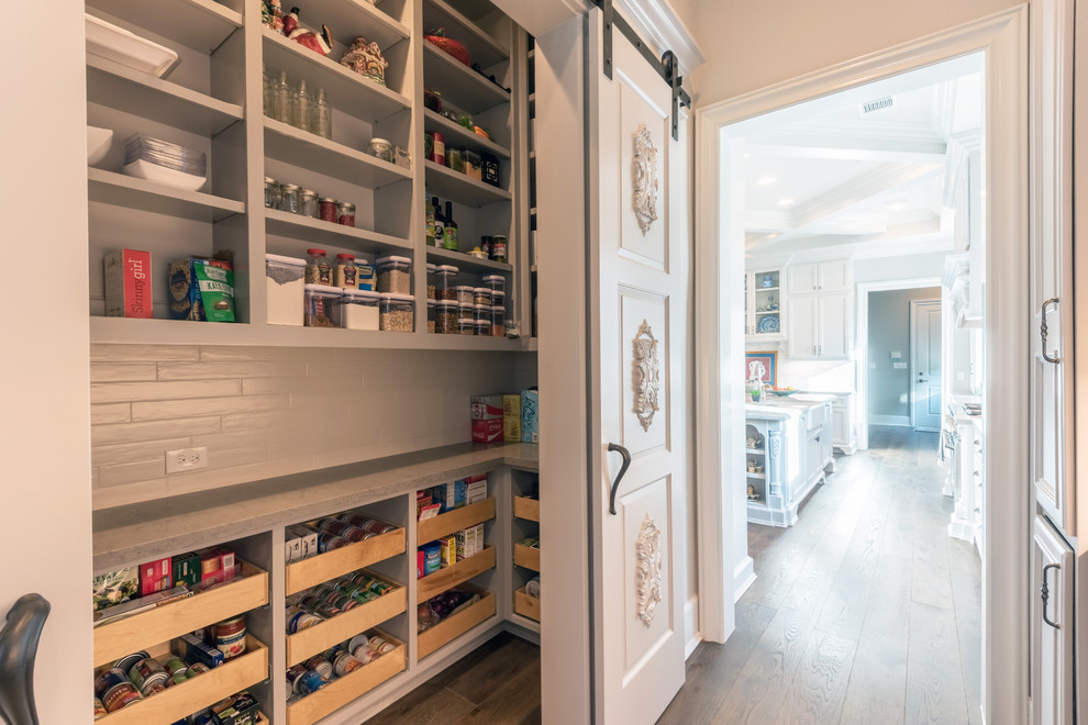 Kitchen pantry - large traditional l-shaped dark wood floor and brown floor kitchen pantry idea in Houston with open cabinets and gray cabinets