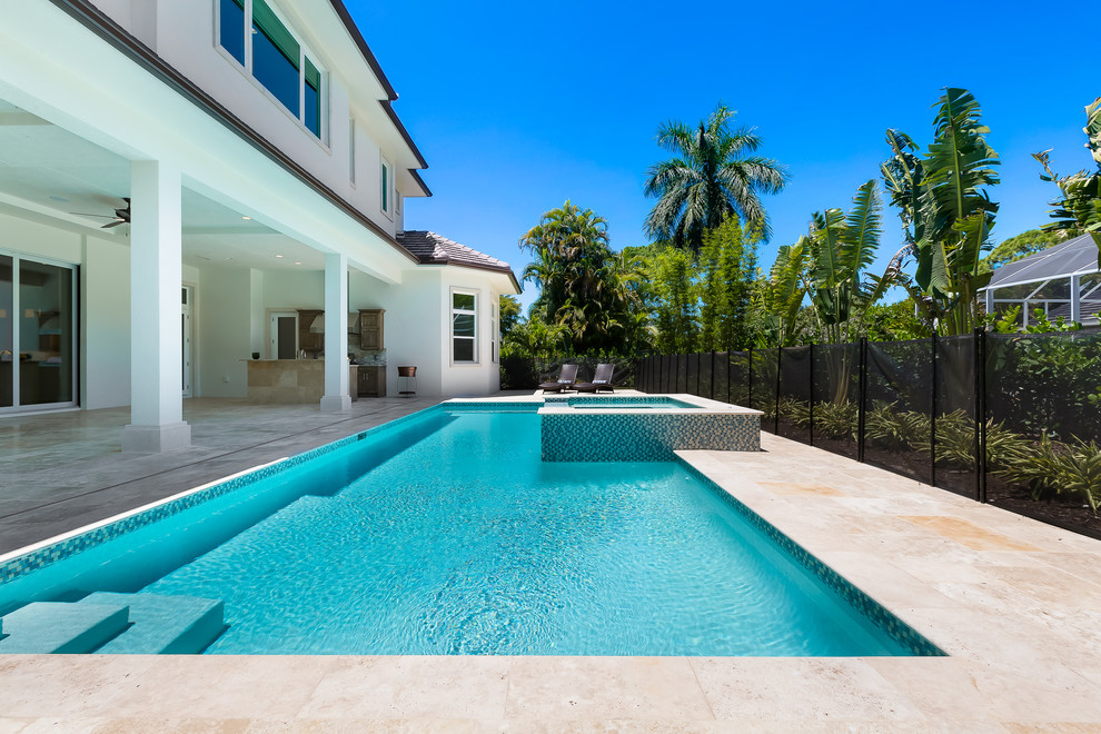 Mid-sized tropical backyard rectangular natural pool in Miami with a hot tub and tile.