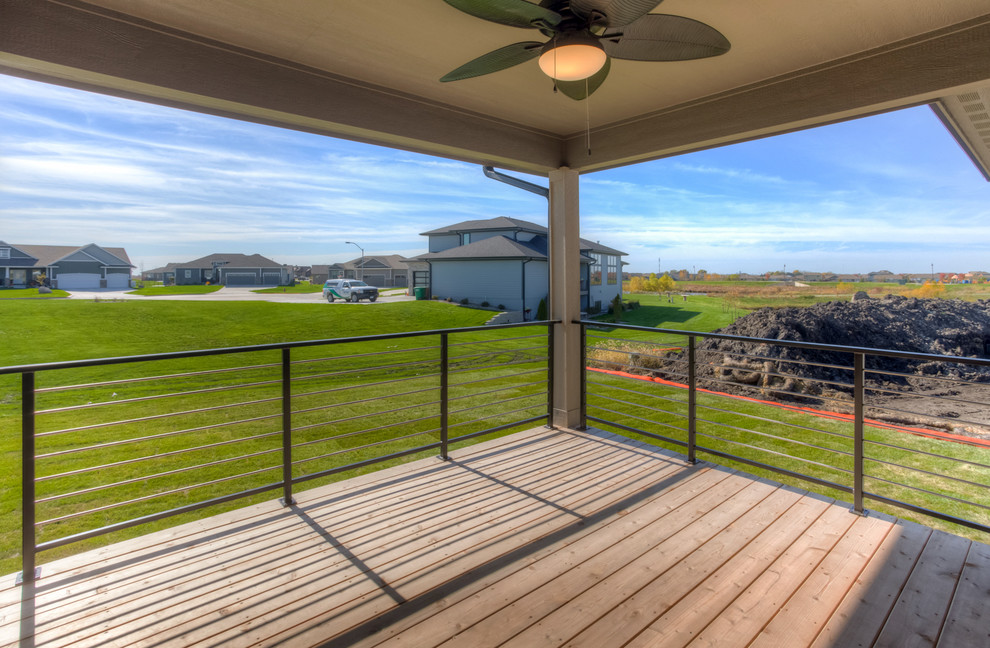 Mid-sized transitional backyard deck photo with a roof extension