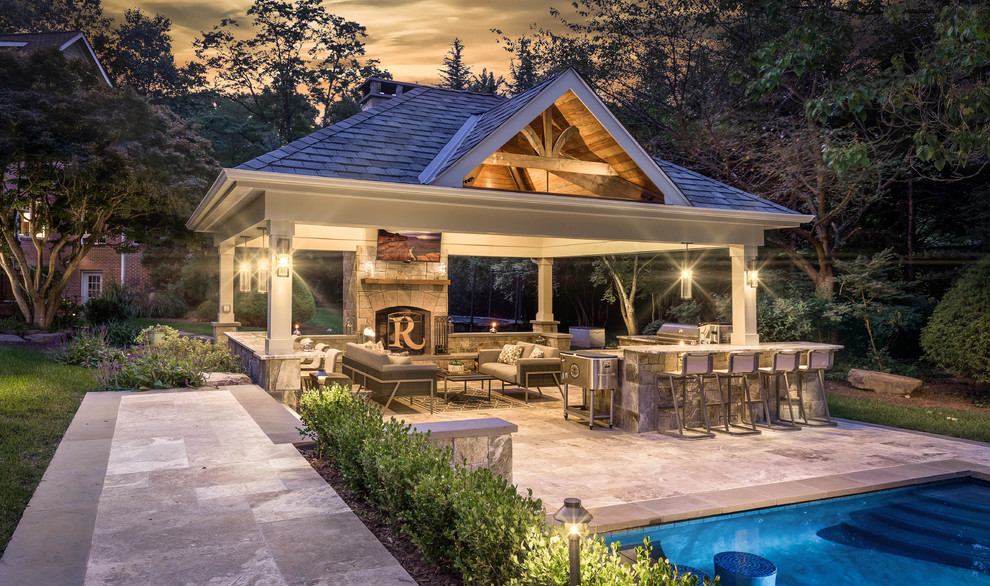 Traditional backyard patio in Richmond with natural stone pavers and a gazebo/cabana.