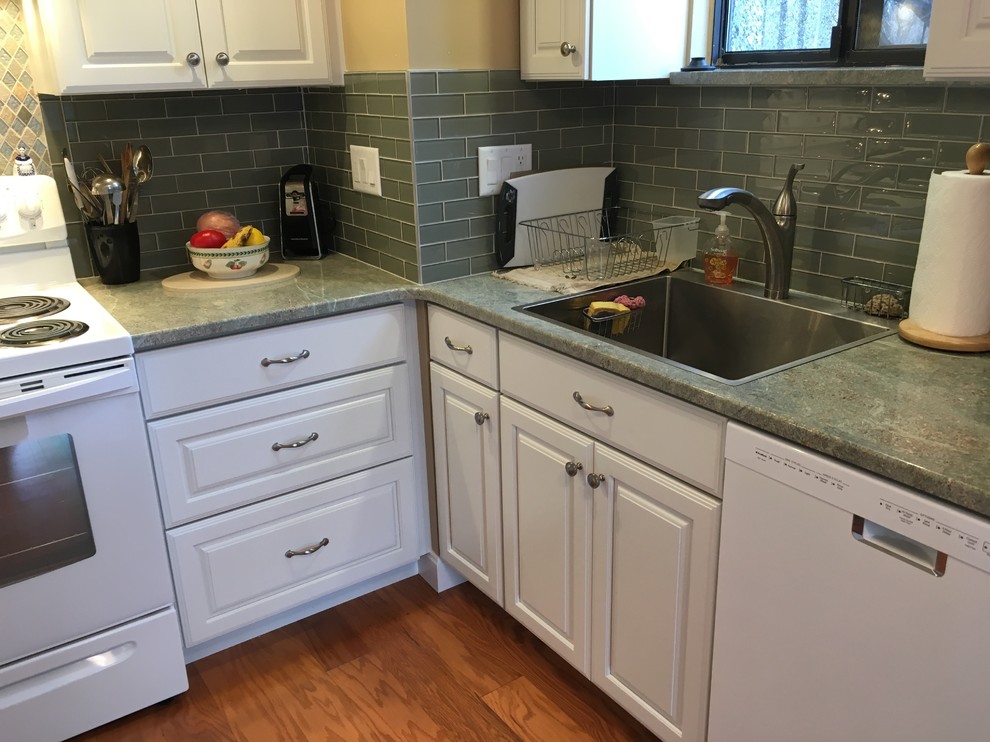Kitchen - transitional u-shaped medium tone wood floor kitchen idea in Boston with a drop-in sink, raised-panel cabinets, white cabinets, granite countertops, green backsplash, glass tile backsplash, white appliances, a peninsula and green countertops