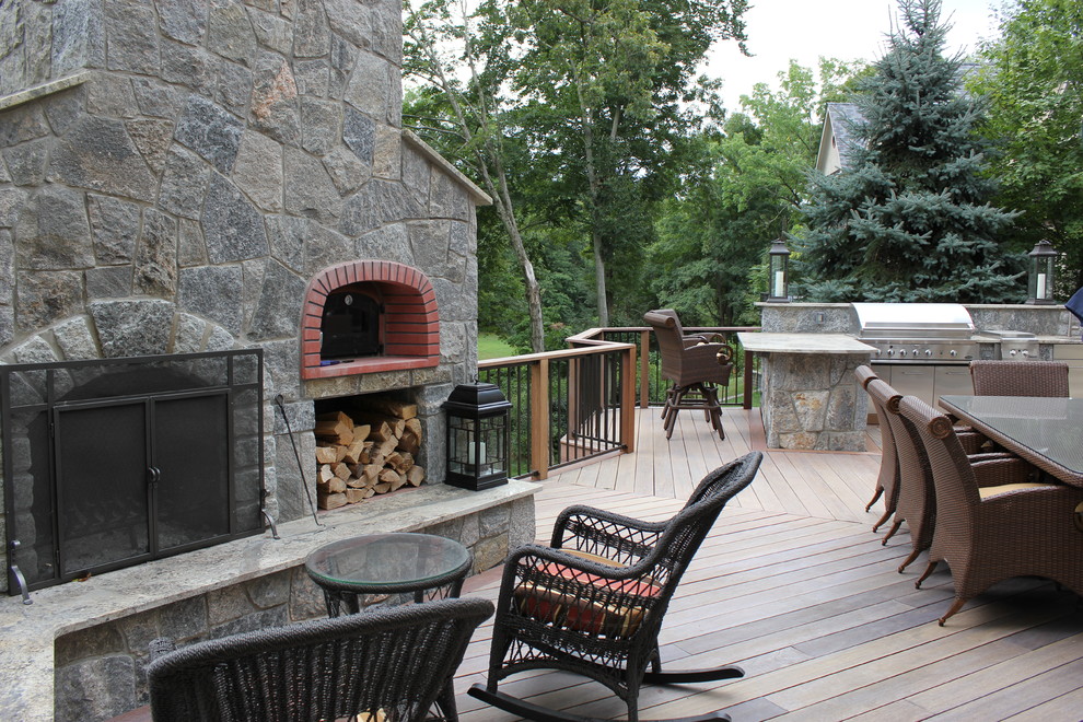 Inspiration for a large transitional backyard deck remodel in Bridgeport with a fire pit and no cover