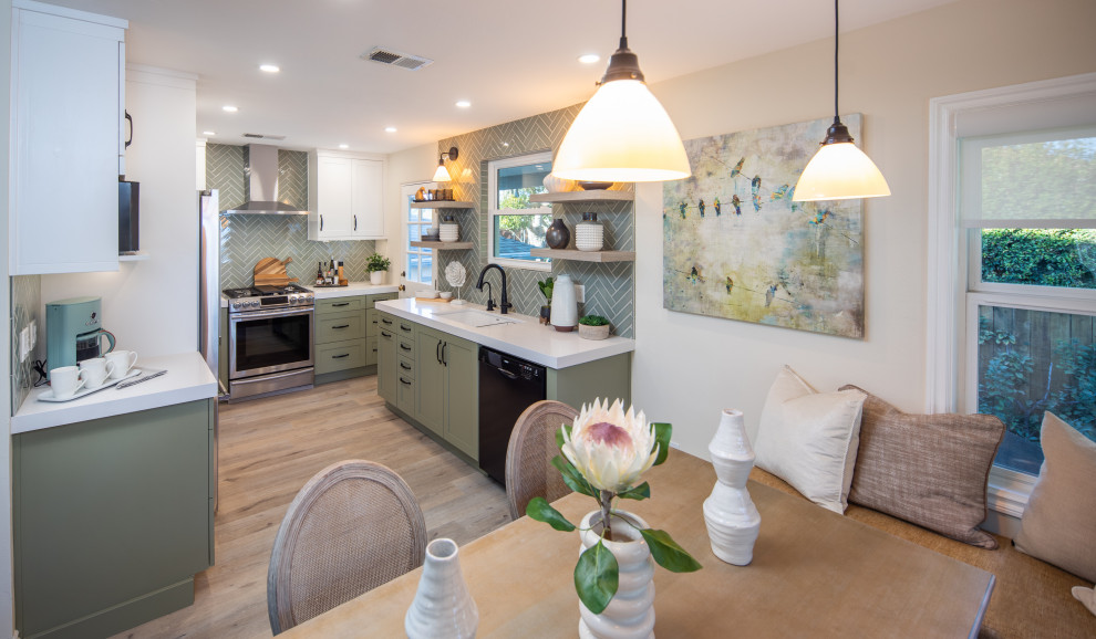 Inspiration for a mid-sized transitional u-shaped vinyl floor and gray floor eat-in kitchen remodel in San Diego with an undermount sink, shaker cabinets, green cabinets, quartz countertops, green backsplash, ceramic backsplash, stainless steel appliances, no island and white countertops