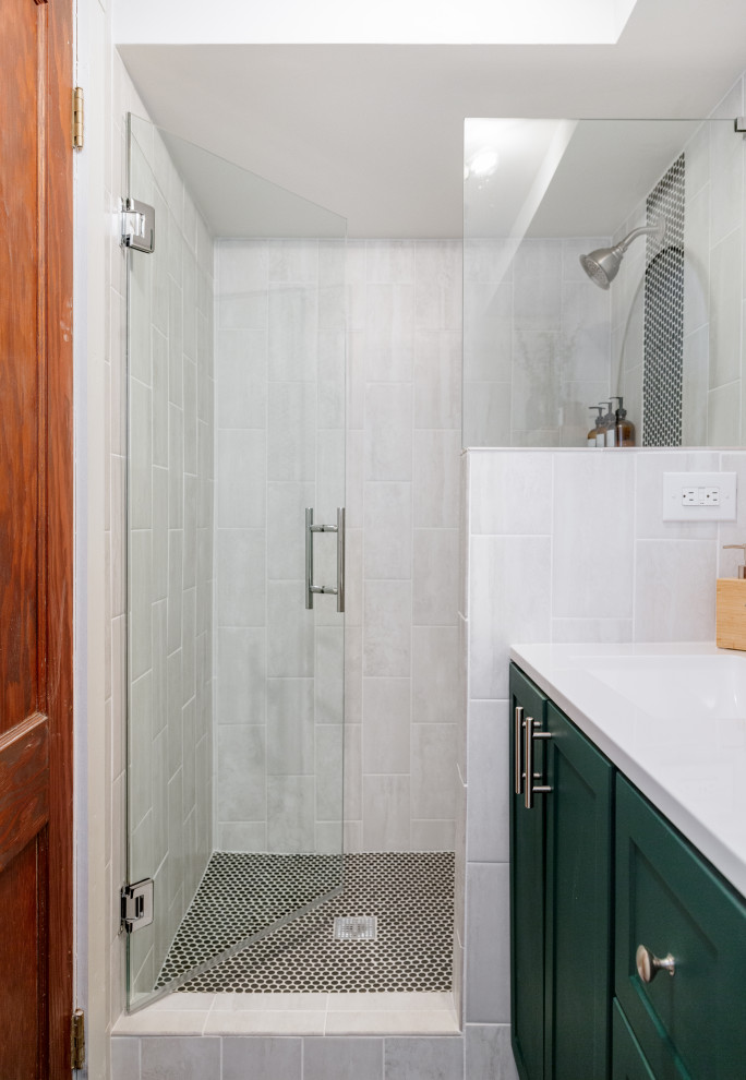 Example of a mid-sized trendy 3/4 cement tile floor, black floor and single-sink alcove shower design in Denver with flat-panel cabinets, green cabinets, a one-piece toilet, white walls, an integrated sink, granite countertops, a hinged shower door, white countertops and a freestanding vanity