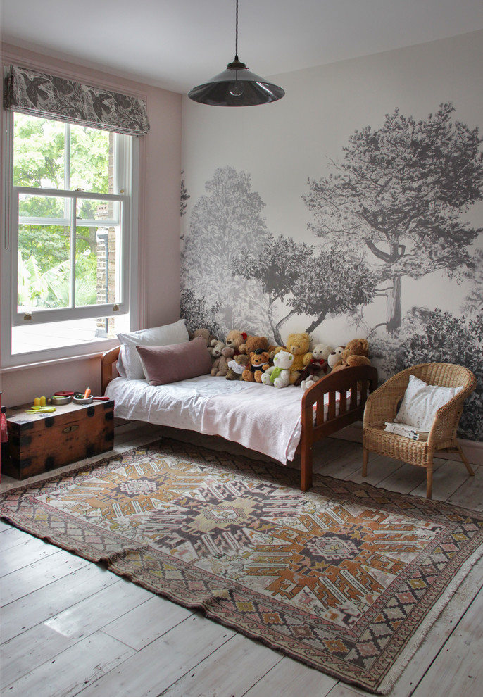 Inspiration for a transitional kids' bedroom for kids 4-10 years old and girls in London with pink walls, painted wood floors and grey floor.