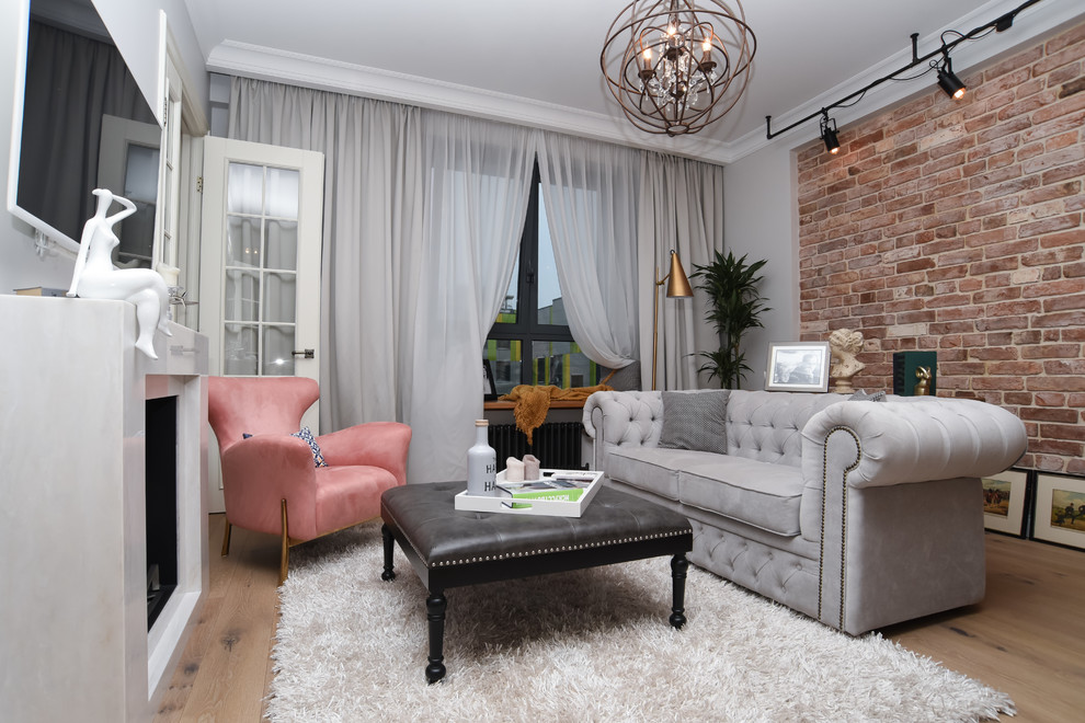 Photo of a mid-sized industrial enclosed living room in Moscow with grey walls, light hardwood floors, a standard fireplace, a stone fireplace surround and beige floor.