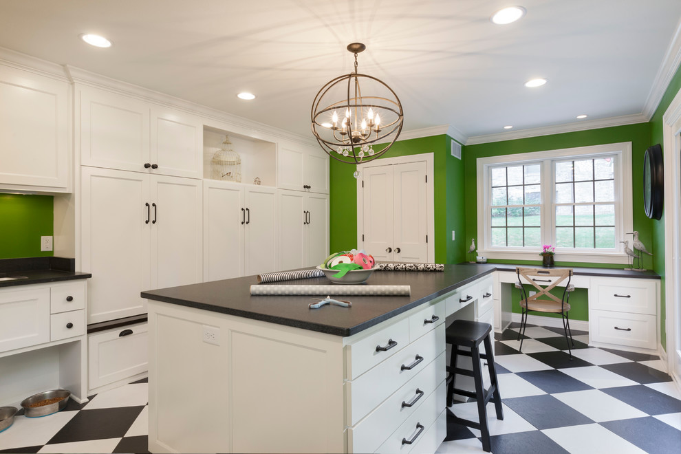 Inspiration for a large transitional l-shaped utility room in Milwaukee with an undermount sink, white cabinets, granite benchtops, green walls, vinyl floors, a side-by-side washer and dryer and shaker cabinets.