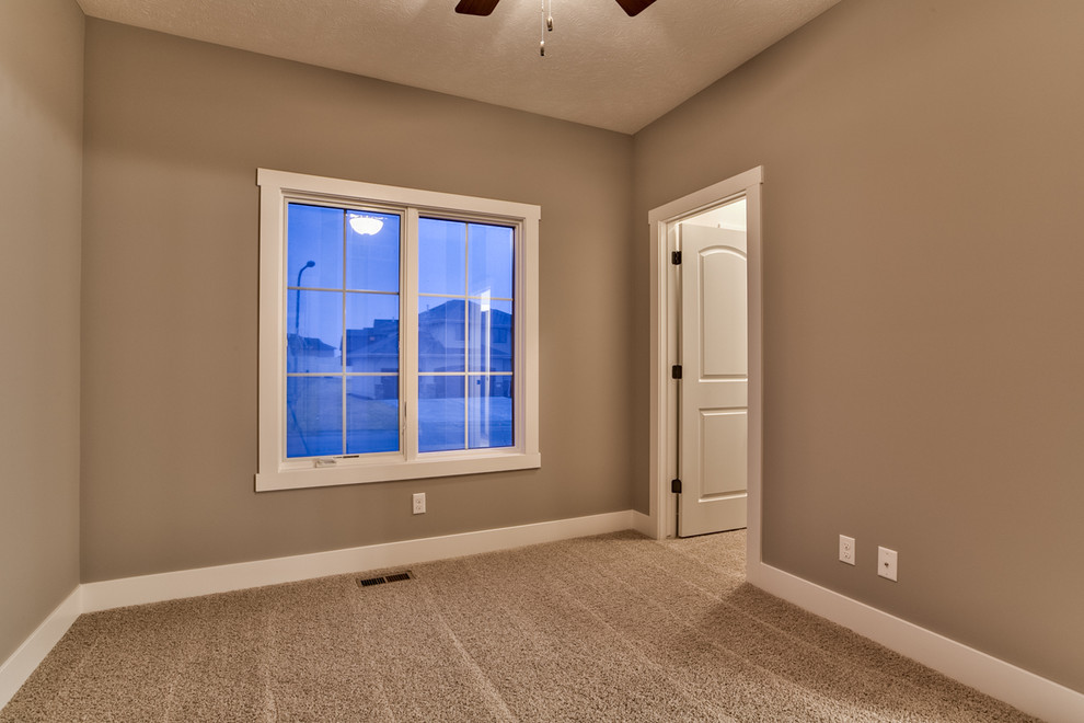 Mid-sized mediterranean guest bedroom in Omaha with grey walls, carpet and no fireplace.
