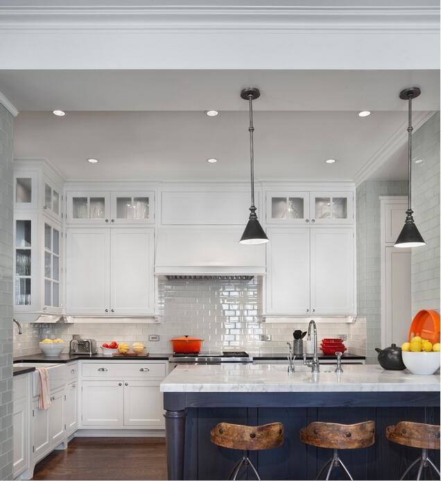 Inspiration for a transitional dark wood floor kitchen remodel with a farmhouse sink, shaker cabinets, white cabinets, marble countertops, gray backsplash, glass tile backsplash, stainless steel appliances and an island