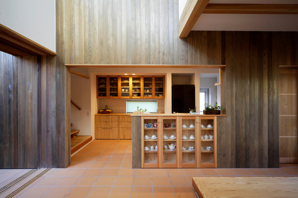 Photo of an asian kitchen with terra-cotta floors and orange floor.