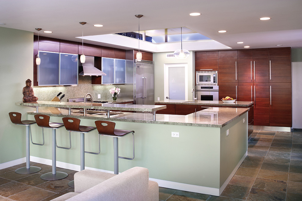 Photo of a mid-sized contemporary u-shaped open plan kitchen in Los Angeles with stainless steel appliances, granite benchtops, a double-bowl sink, flat-panel cabinets, dark wood cabinets, mosaic tile splashback, green splashback, slate floors, with island and green benchtop.