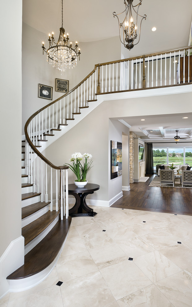 Photo of an expansive traditional foyer in Tampa with beige walls and marble floors.