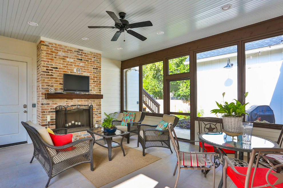 Mid-sized traditional backyard patio in Austin with with fireplace, tile and a roof extension.