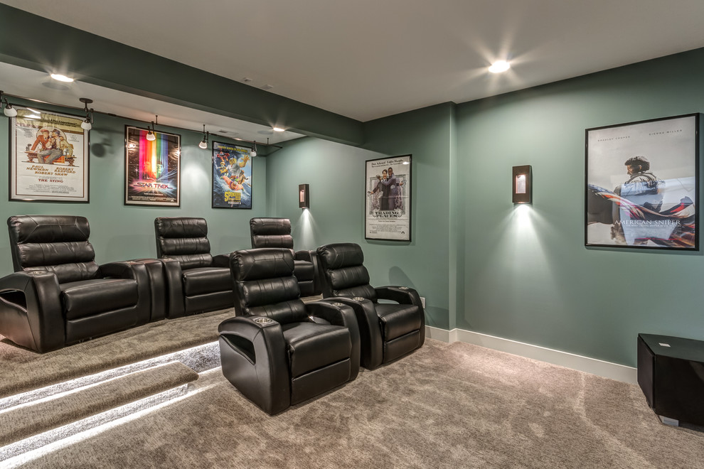 Traditional enclosed home theatre in Other with green walls, carpet and grey floor.