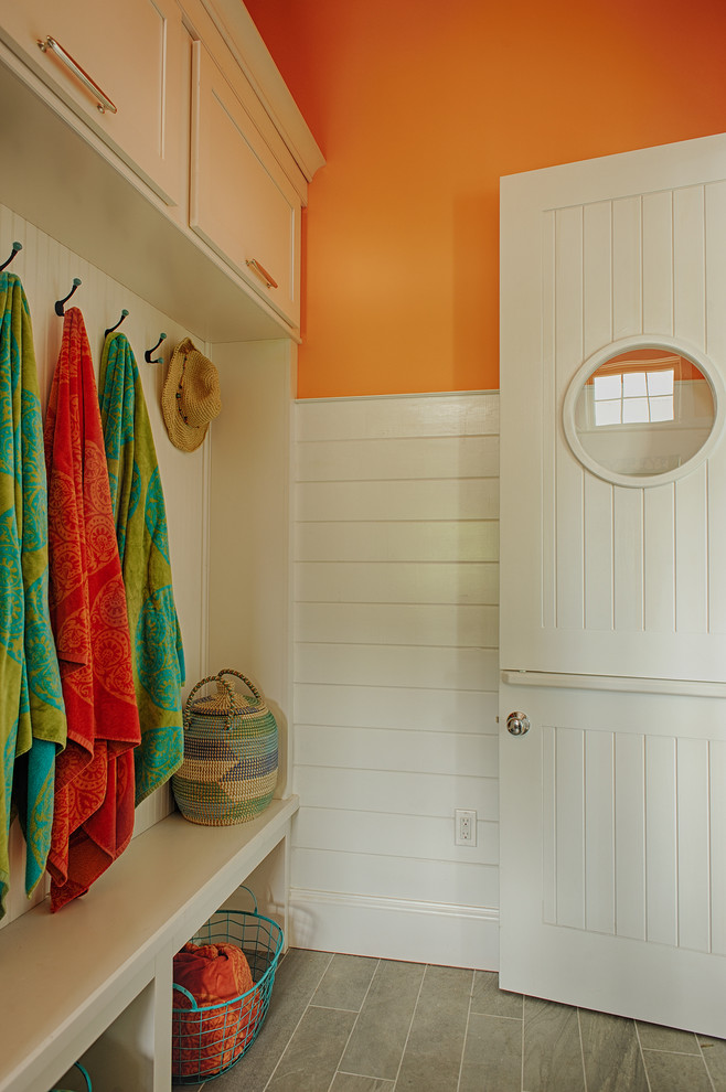 Design ideas for a beach style mudroom in Philadelphia with orange walls.