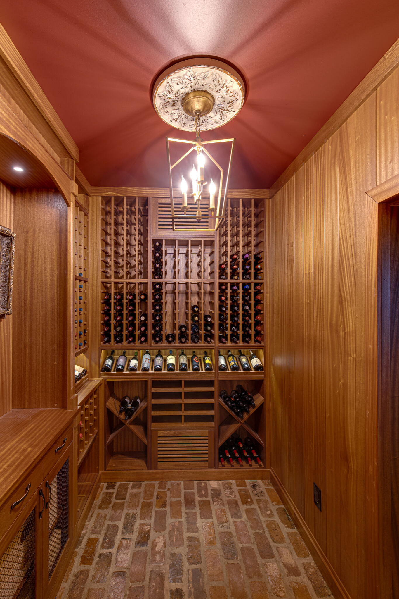 Secret passageway wine cellar. Basement layout with all mahogany racking.