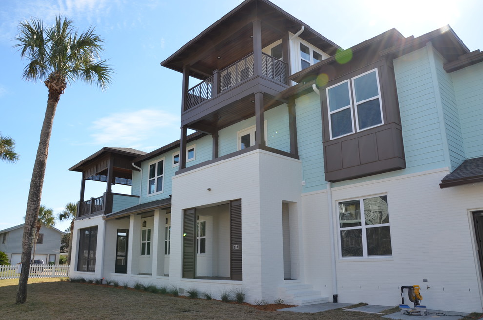 Design ideas for a beach style three-storey white exterior in Jacksonville.