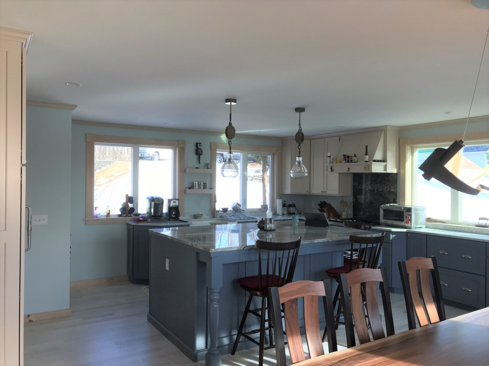 Large transitional eat-in kitchen in Portland Maine with flat-panel cabinets.