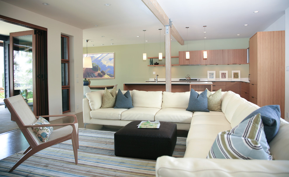 This is an example of a large beach style open concept living room in Other with concrete floors.