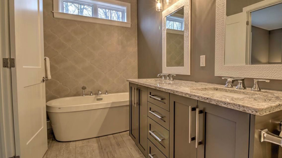 Mid-sized transitional master medium tone wood floor and beige floor freestanding bathtub photo with shaker cabinets, gray cabinets, brown walls, an undermount sink, granite countertops and gray countertops
