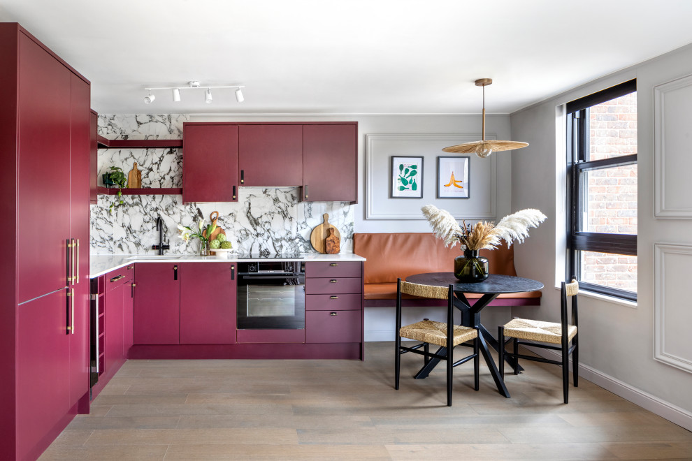 Example of a small trendy l-shaped medium tone wood floor and brown floor eat-in kitchen design in London with an integrated sink, flat-panel cabinets, purple cabinets, quartzite countertops, multicolored backsplash, marble backsplash, black appliances and white countertops