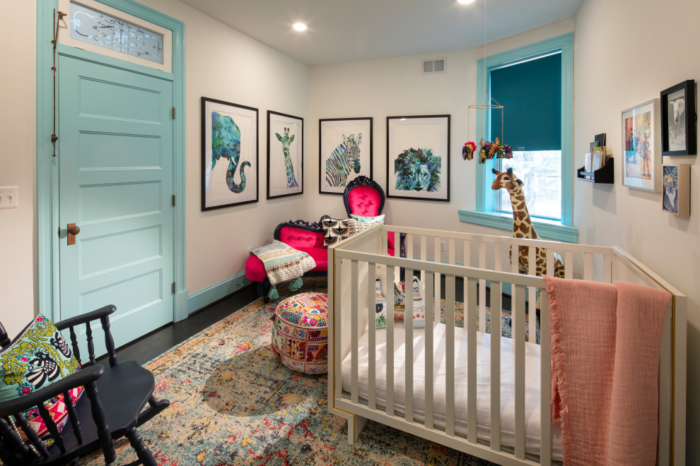 Adams Morgan Classic DC Rowhouse - The owners of this stately Adams Morgan rowhouse wanted to reconfigure rooms on the two upper levels and create a better layout for the nursery, guest room and au pair bathroom on the second floor. Our crews fully gutted and reframed the floors and walls of the front rooms, taking the opportunity of open walls to increase energy-efficiency with spray foam insulation at exposed exterior walls.
The middle bedroom on the second floor serves as a nursery. Bright turquoise doors and trim set the tone for the colorful space.