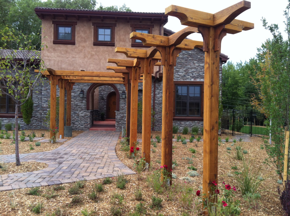 Inspiration for a mediterranean front yard concrete paver full sun entryway remodel in Denver