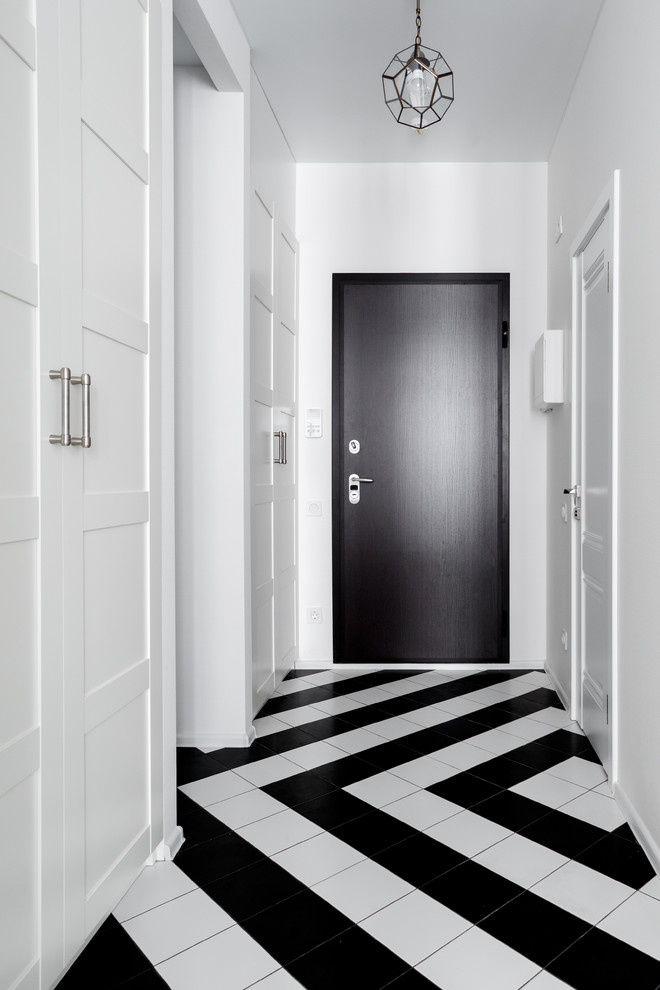 Inspiration for a transitional front door in Moscow with white walls, a single front door and a black front door.