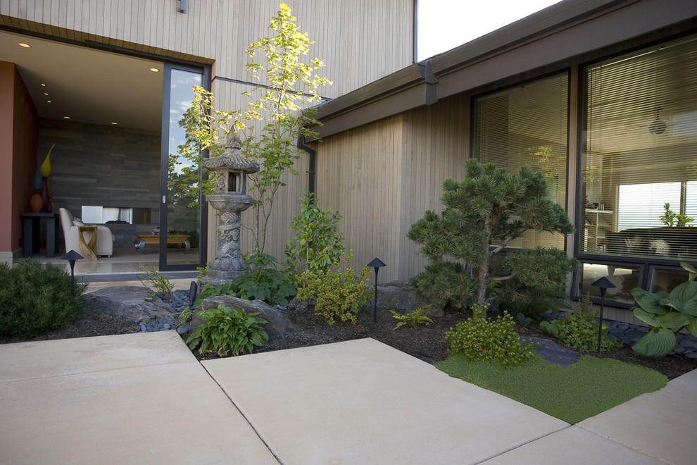 This is an example of a contemporary exterior in Portland with wood siding.